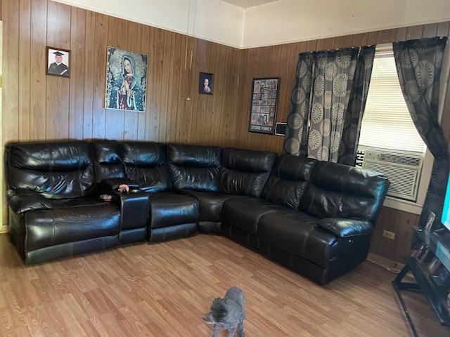 living room featuring cooling unit, light hardwood / wood-style floors, and wood walls