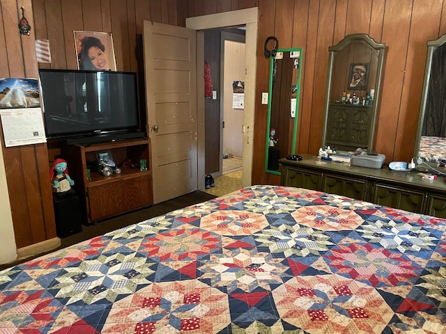 bedroom featuring wood walls