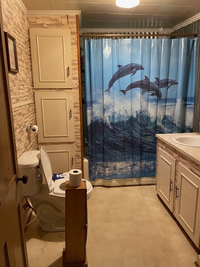 full bathroom with vanity, shower / bath combo with shower curtain, and toilet