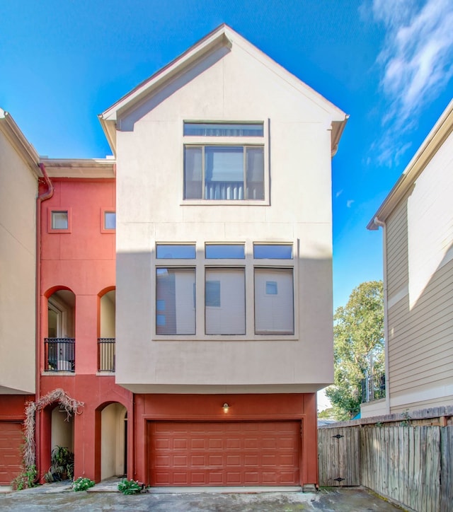 view of front of home with a balcony and a garage