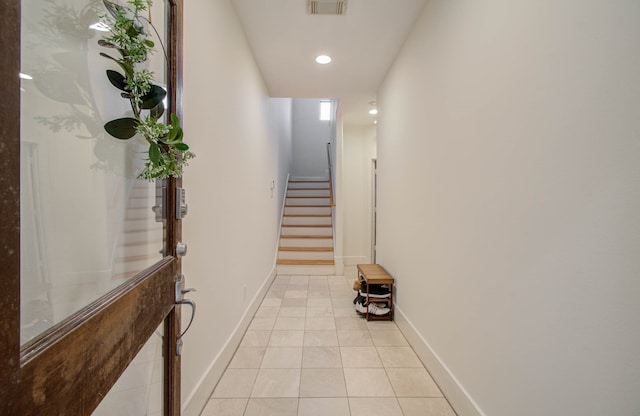 hall featuring light tile patterned floors