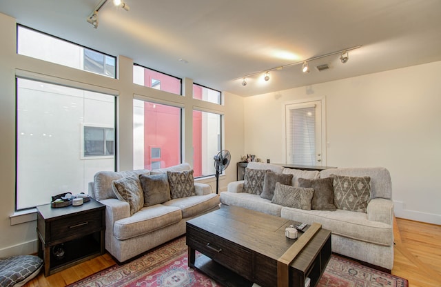 living room with track lighting and hardwood / wood-style flooring