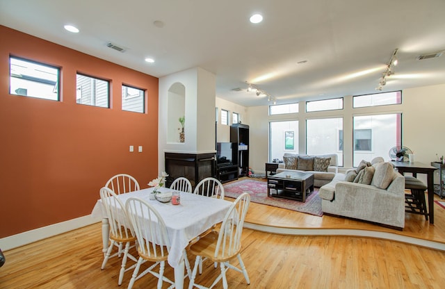 dining space with light hardwood / wood-style flooring and plenty of natural light