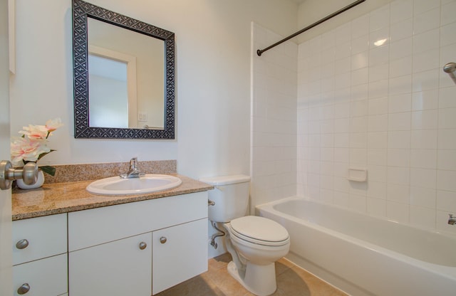 full bathroom with tiled shower / bath, vanity, and toilet