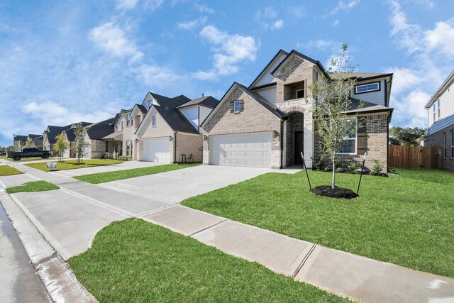 view of front of property featuring a garage and a front lawn