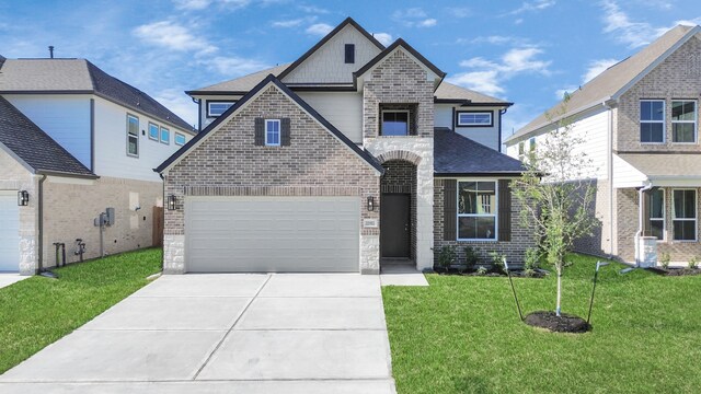 view of front of house with a front lawn and a garage