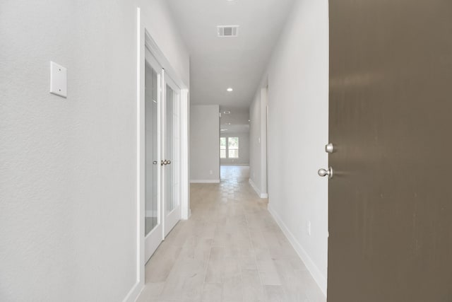 hallway with light wood-type flooring