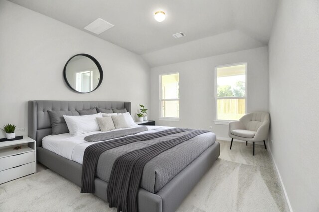 carpeted bedroom with vaulted ceiling