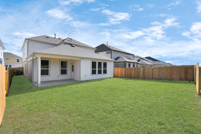 rear view of property featuring a patio and a lawn