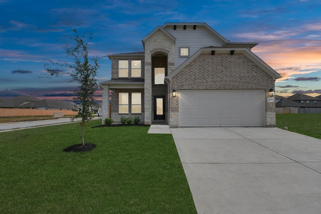 view of front of home with a yard and a garage