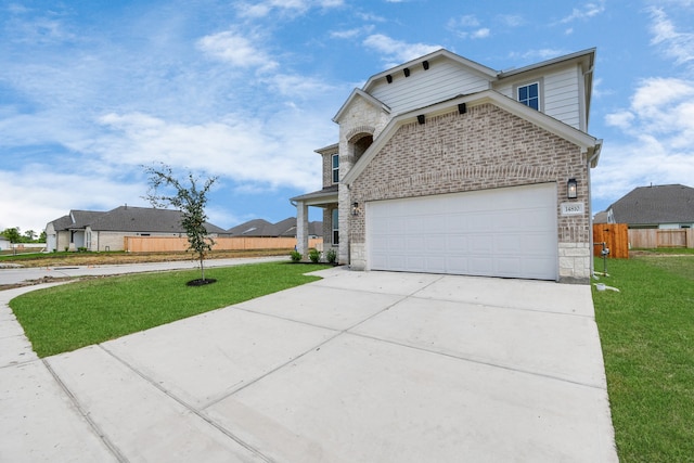 view of front of property with a front yard and a garage