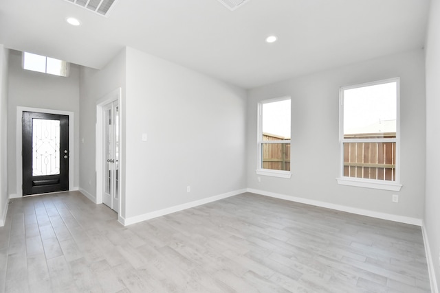 entrance foyer featuring light hardwood / wood-style floors and a wealth of natural light