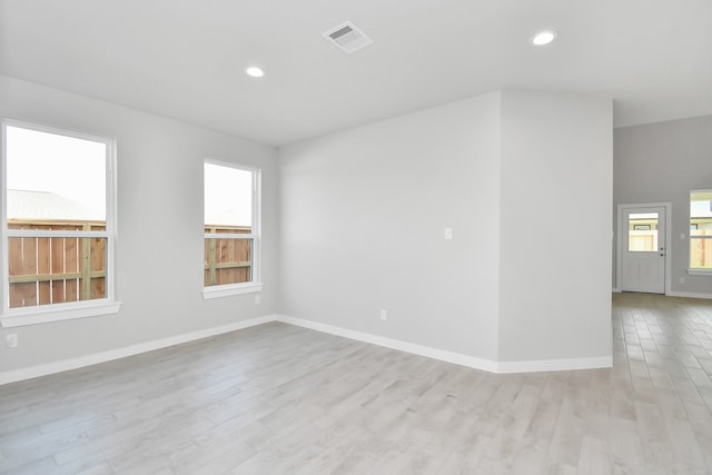 empty room featuring light hardwood / wood-style floors and a healthy amount of sunlight