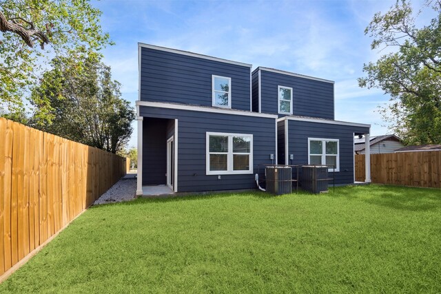 back of property featuring a lawn and cooling unit