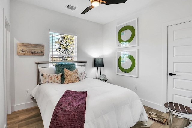 bedroom with hardwood / wood-style flooring and ceiling fan