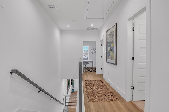 corridor with light hardwood / wood-style flooring