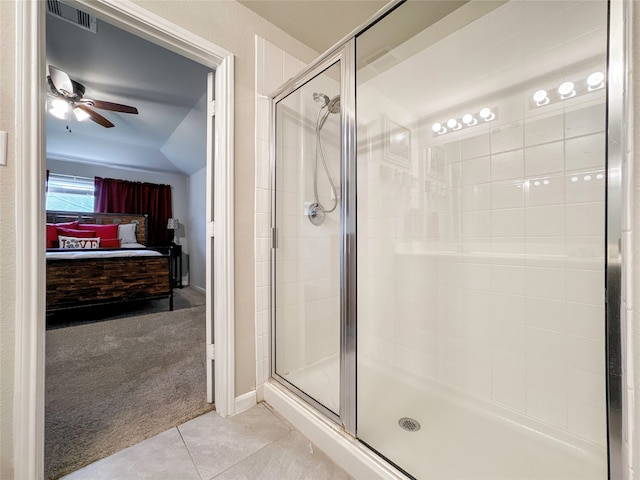 bathroom featuring ceiling fan, tile patterned floors, and an enclosed shower