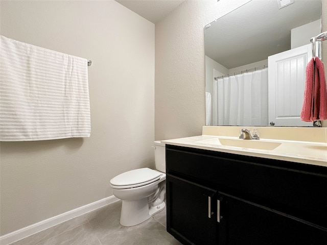 bathroom featuring vanity, toilet, and tile patterned floors