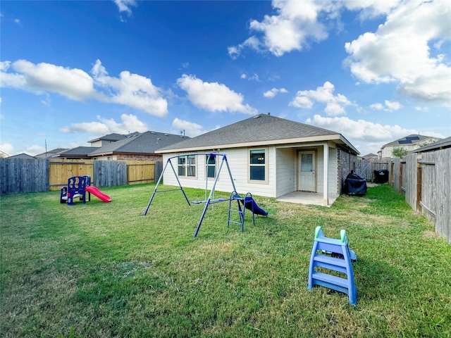 rear view of property featuring a patio area and a lawn