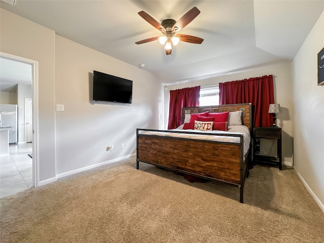 bedroom featuring white fridge, light carpet, vaulted ceiling, and ceiling fan