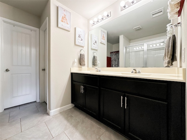 bathroom featuring vanity, curtained shower, and tile patterned flooring