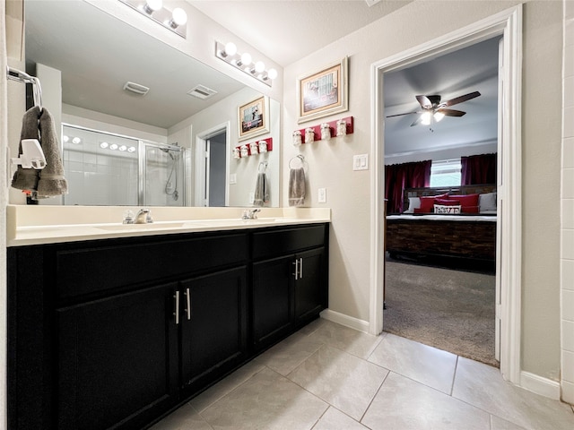 bathroom with vanity, ceiling fan, tile patterned floors, and a shower with shower door