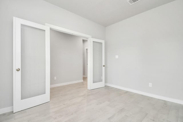 15714 Walnut Leaf Ln, Cypress, TX 77429 - unfurnished bedroom with light hardwood / wood-style floors, a closet, and french doors