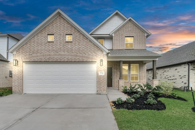 view of front of house with a garage and a yard