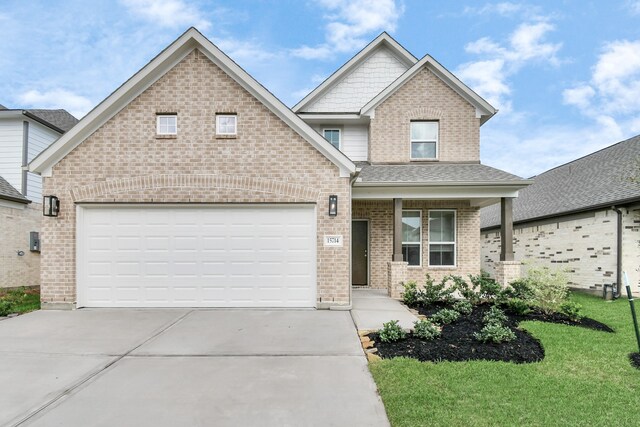 view of front facade featuring a front lawn and a garage