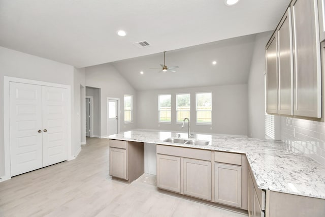 15714 Walnut Leaf Ln, Cypress, TX 77429 - kitchen with tasteful backsplash, sink, vaulted ceiling, light hardwood / wood-style floors, and kitchen peninsula