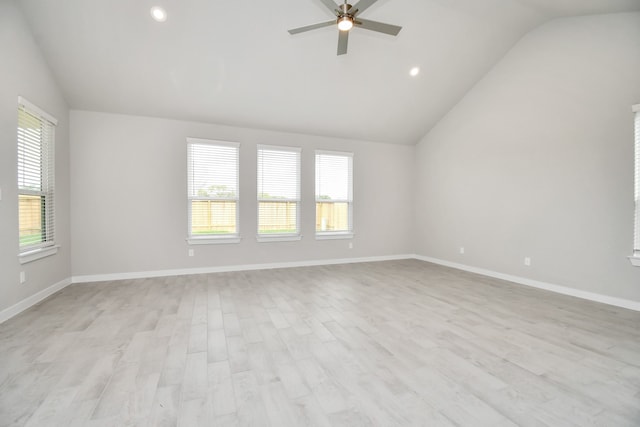 spare room featuring light hardwood / wood-style floors, lofted ceiling, and ceiling fan