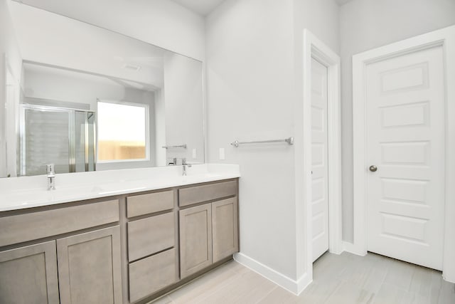 bathroom with vanity and a shower with shower door