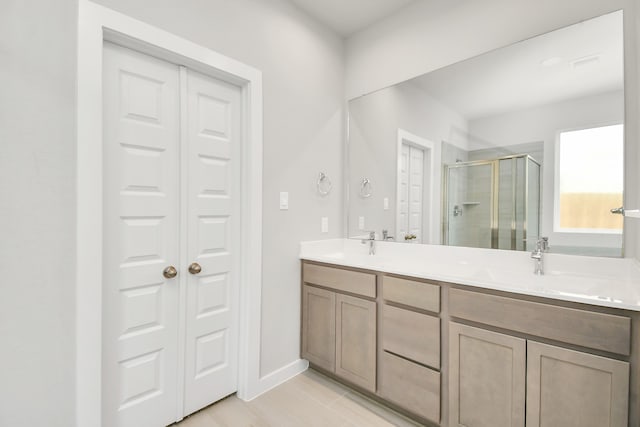 bathroom featuring hardwood / wood-style floors, an enclosed shower, and vanity