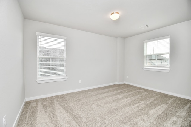 carpeted spare room with plenty of natural light