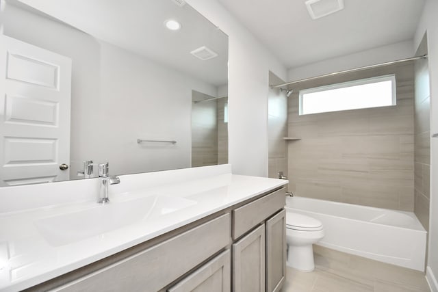 full bathroom featuring tiled shower / bath, toilet, and vanity