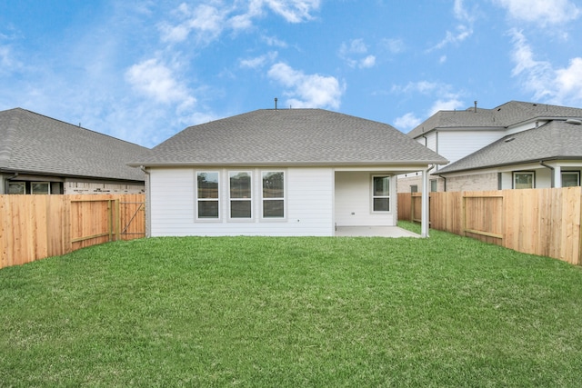 rear view of house with a lawn and a patio area