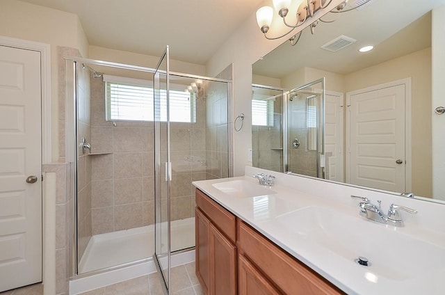 bathroom featuring tile patterned flooring, vanity, and an enclosed shower