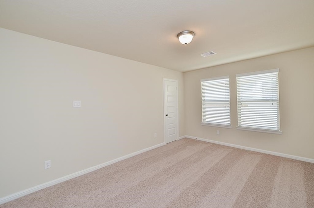 spare room with light colored carpet