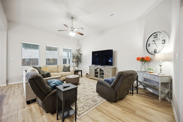 living room with light hardwood / wood-style flooring and ceiling fan