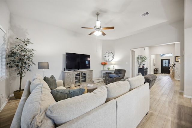 living room with light hardwood / wood-style flooring and ceiling fan