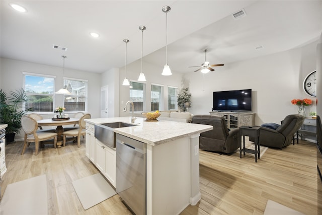 kitchen with light wood-type flooring, ceiling fan, decorative light fixtures, stainless steel dishwasher, and light stone counters