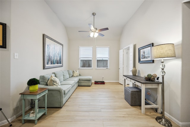 living room with vaulted ceiling, light wood-type flooring, and ceiling fan