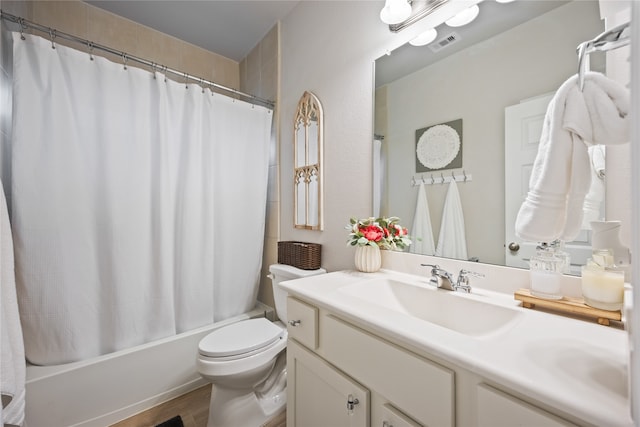 full bathroom featuring vanity, toilet, hardwood / wood-style flooring, and shower / bath combination with curtain