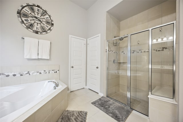 bathroom with tile patterned floors and shower with separate bathtub