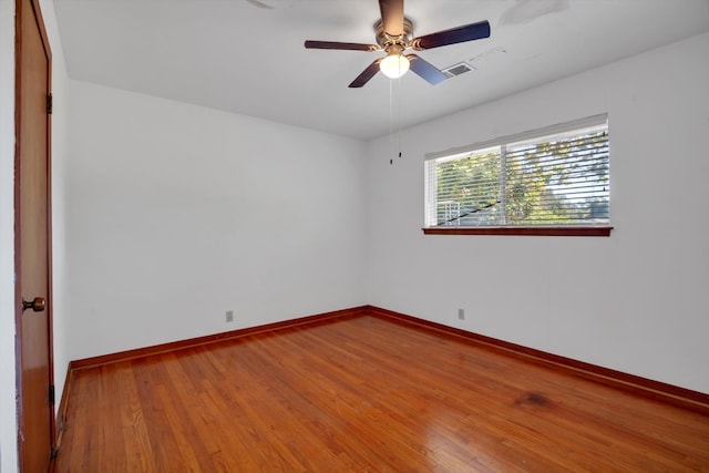 spare room featuring hardwood / wood-style flooring and ceiling fan