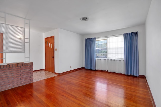 unfurnished room featuring wood-type flooring