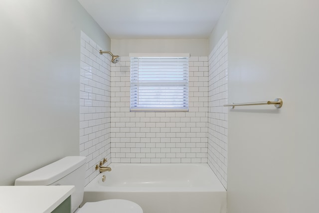 full bathroom with vanity, toilet, and tiled shower / bath combo