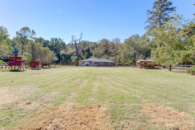 view of yard with a playground and a rural view