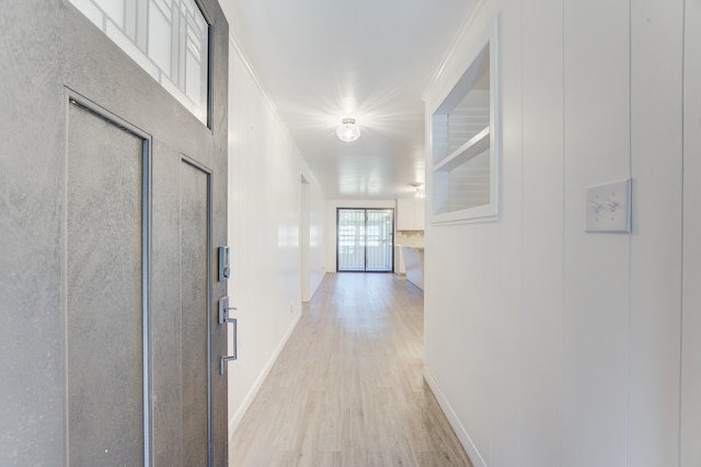 hall featuring crown molding and light wood-type flooring