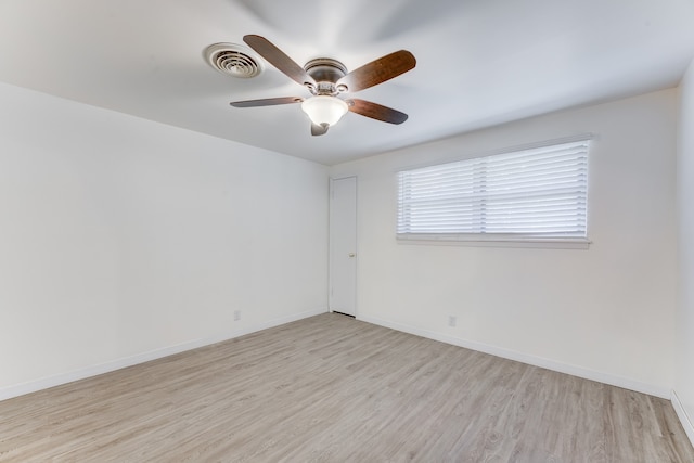 empty room with ceiling fan and light hardwood / wood-style flooring